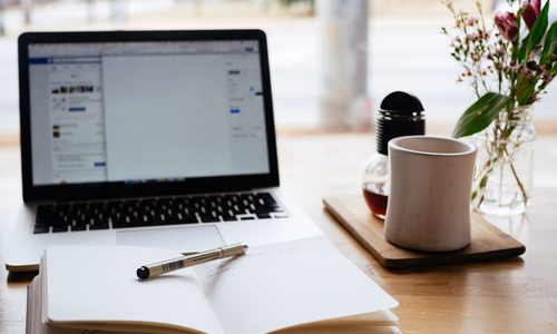 Open notebook and pen on a desk representing the best note-taking apps in 2026 including Obsidian, Notion and Logseq