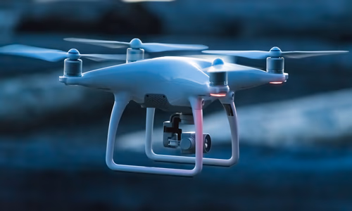 A high-tech interceptor drone in flight, using computer vision to track multiple targets in a complex urban environment.
