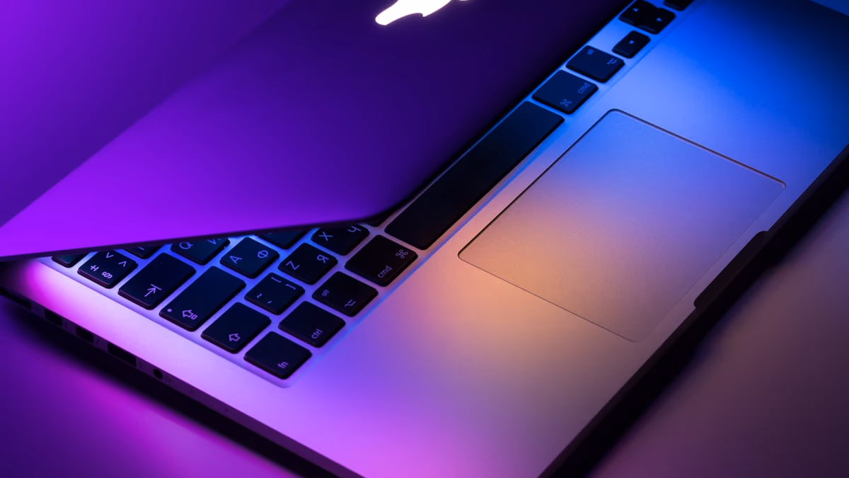 Apple MacBook Pro laptop on a dark surface representing the upcoming M6 chip 2nm OLED MacBook Pro expected at WWDC 2026