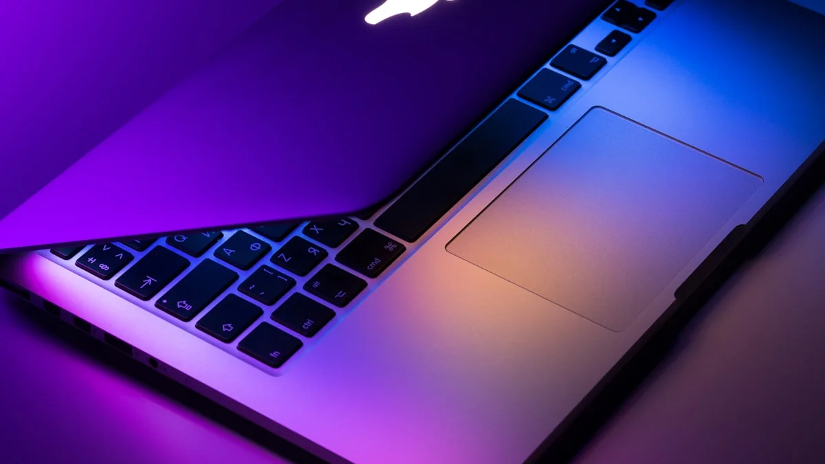 Apple MacBook laptop in colorful blush pink color on a clean desk representing the new MacBook Neo 2026 review specs and price