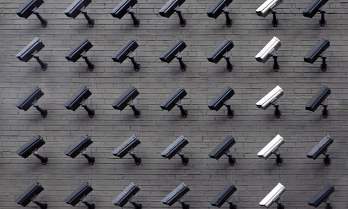 CCTV security cameras on a building wall representing India's ban on Chinese surveillance cameras from Hikvision and Dahua effective April 1 2026